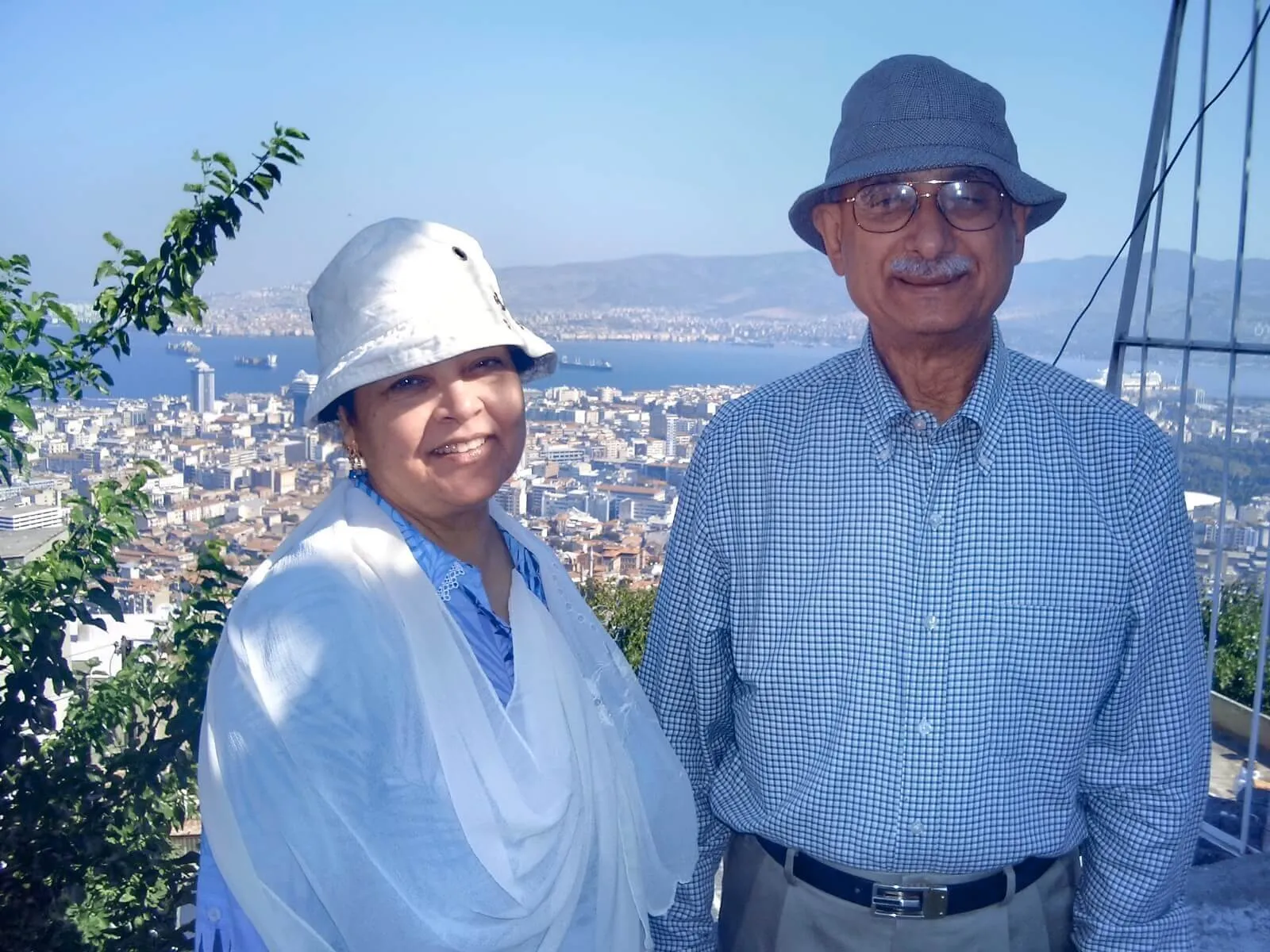 Drs. Madad overlooking a city from a hillside